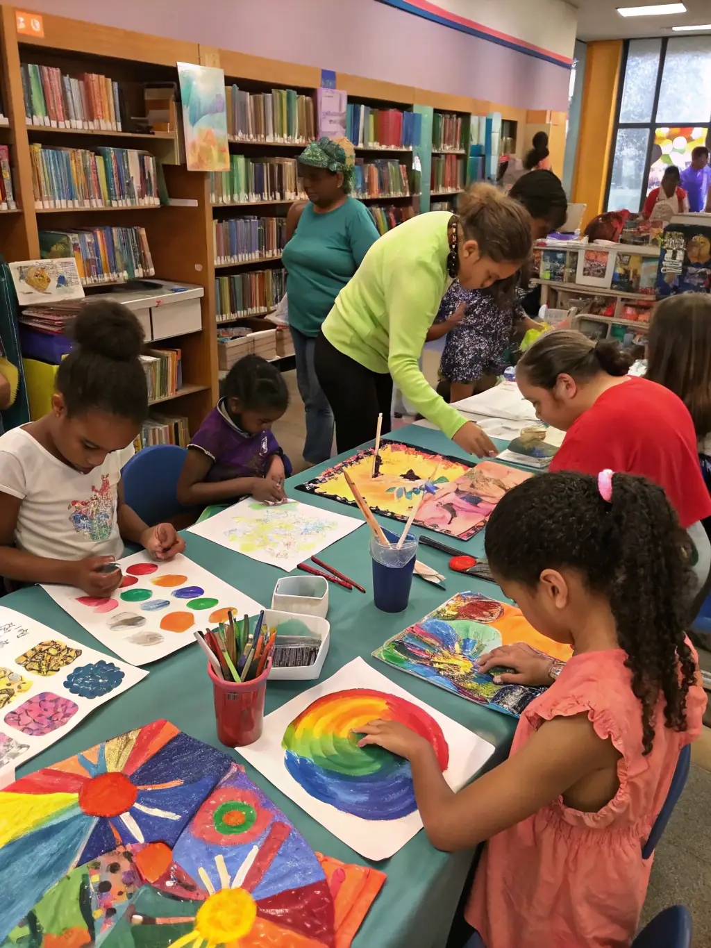 A dynamic shot of an artistic workshop in progress, showcasing participants of different ages working on various art projects, with instructors providing guidance and encouragement.